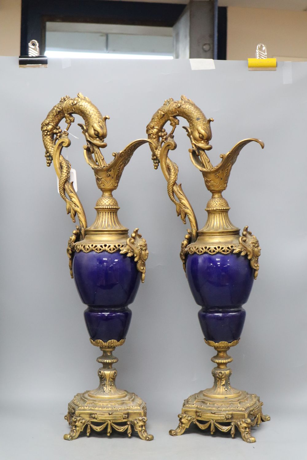 A pair of Louis XIV style gilt metal and porcelain ewers, height 62cm